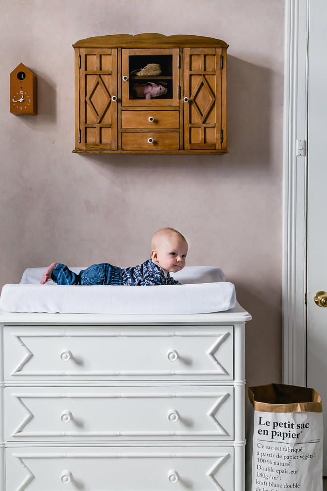 Small eclectic gender-neutral nursery in Melbourne with pink walls, carpet and white floor.