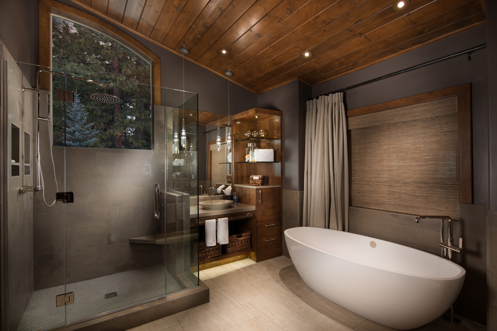 Photo of a country bathroom in Sacramento with a vessel sink, flat-panel cabinets, dark wood cabinets, a freestanding tub and an alcove shower.