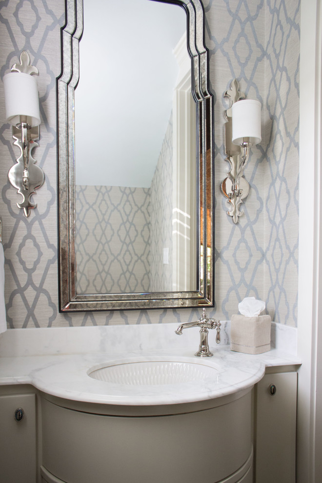 Inspiration for a small traditional powder room in Houston with an undermount sink, furniture-like cabinets, marble benchtops, grey cabinets and white benchtops.