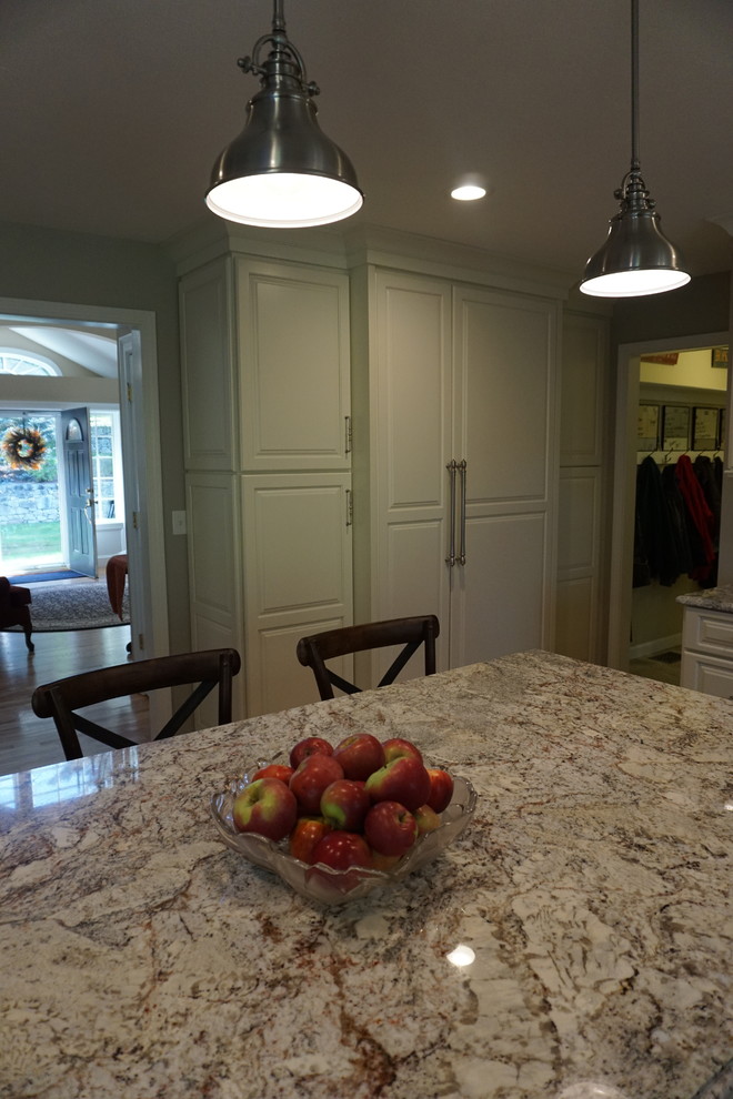 Large elegant l-shaped eat-in kitchen photo in Boston with a farmhouse sink, raised-panel cabinets, white cabinets, quartz countertops, white backsplash, ceramic backsplash, stainless steel appliances and an island