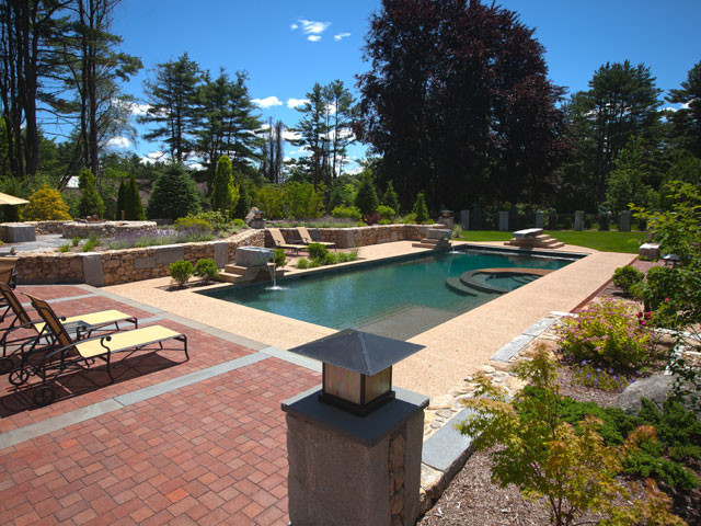 Inspiration for a large backyard concrete paver and rectangular natural hot tub remodel in Boston