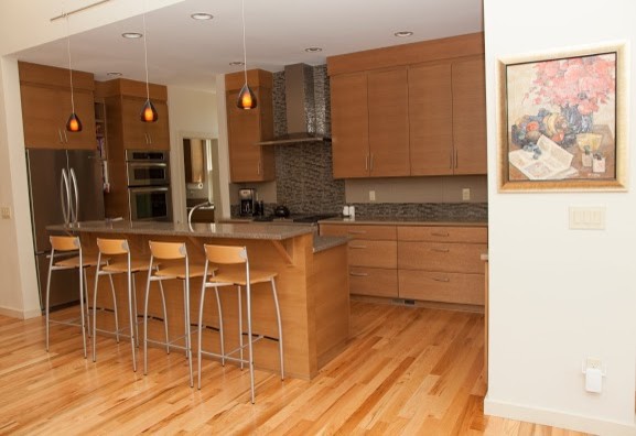Inspiration for a mid-sized contemporary galley light wood floor eat-in kitchen remodel in Portland with an undermount sink, flat-panel cabinets, light wood cabinets, quartz countertops, multicolored backsplash and stainless steel appliances