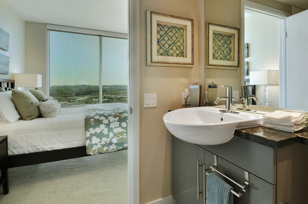 Example of a small transitional 3/4 white tile and ceramic tile ceramic tile drop-in bathtub design in Austin with a vessel sink, flat-panel cabinets, gray cabinets, granite countertops, a one-piece toilet and gray walls