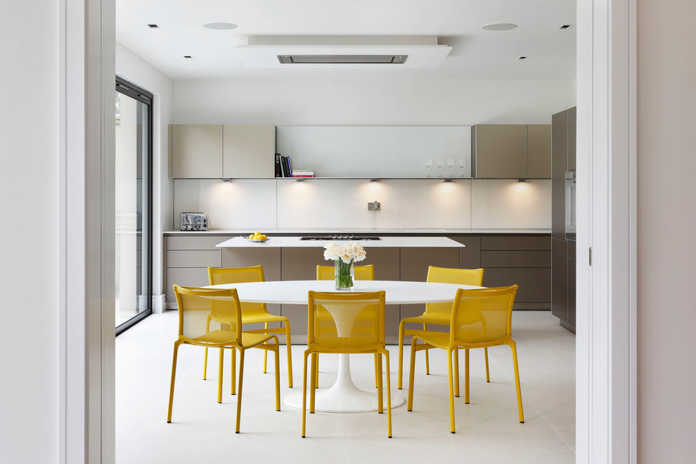 Medium sized contemporary grey and yellow galley kitchen/diner in London with flat-panel cabinets, brown cabinets, quartz worktops, integrated appliances, an island, grey floors and white splashback.