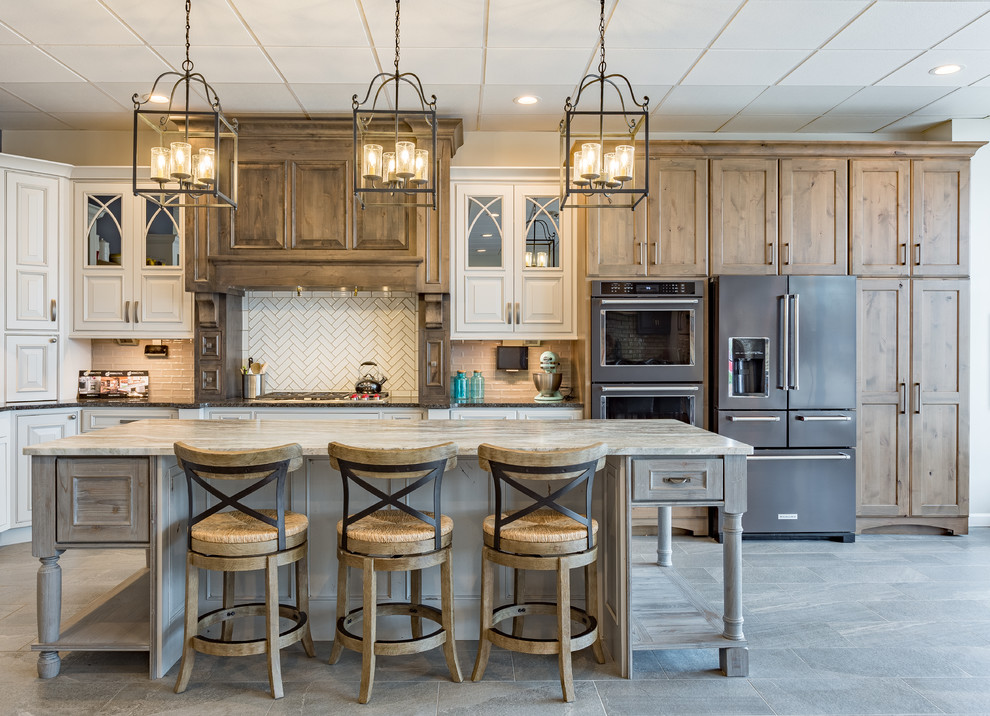 Open concept kitchen - large transitional l-shaped gray floor open concept kitchen idea with an island, shaker cabinets, medium tone wood cabinets, white backsplash, stainless steel appliances, granite countertops and subway tile backsplash
