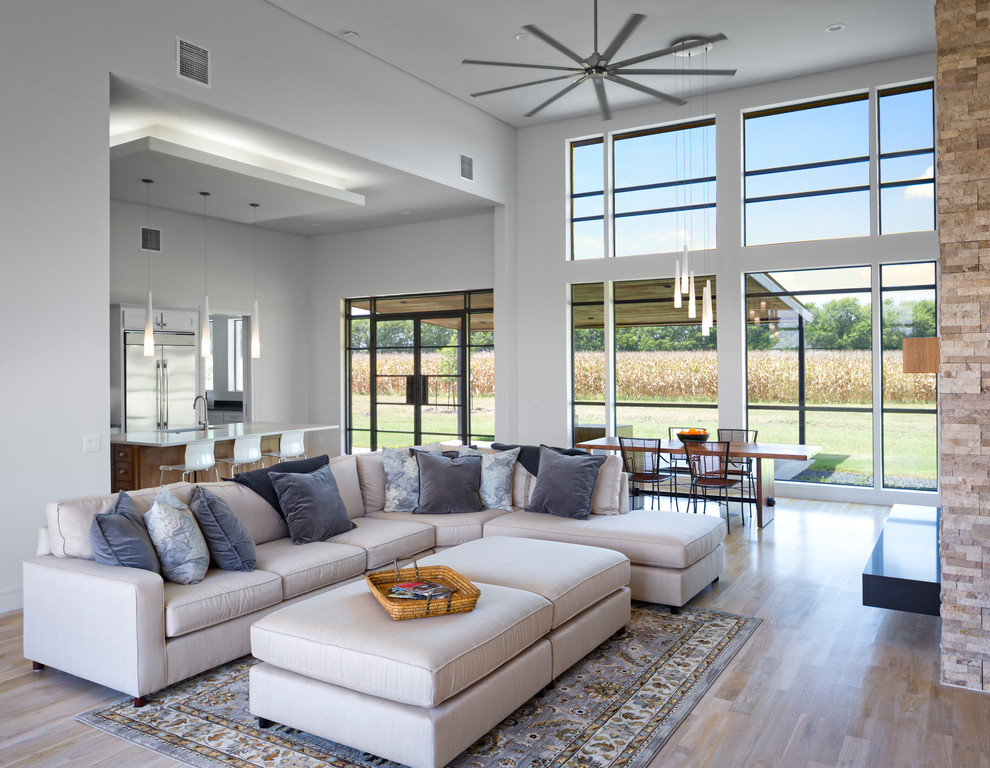 This is an example of a mid-sized transitional open concept living room in Dallas with white walls, brown floor and medium hardwood floors.