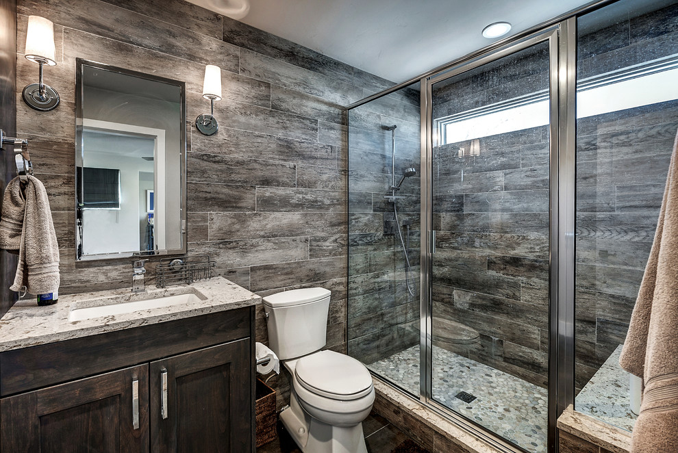 Inspiration for a country 3/4 bathroom in Denver with shaker cabinets, dark wood cabinets, an alcove shower, a two-piece toilet, brown walls, dark hardwood floors, an undermount sink and a hinged shower door.