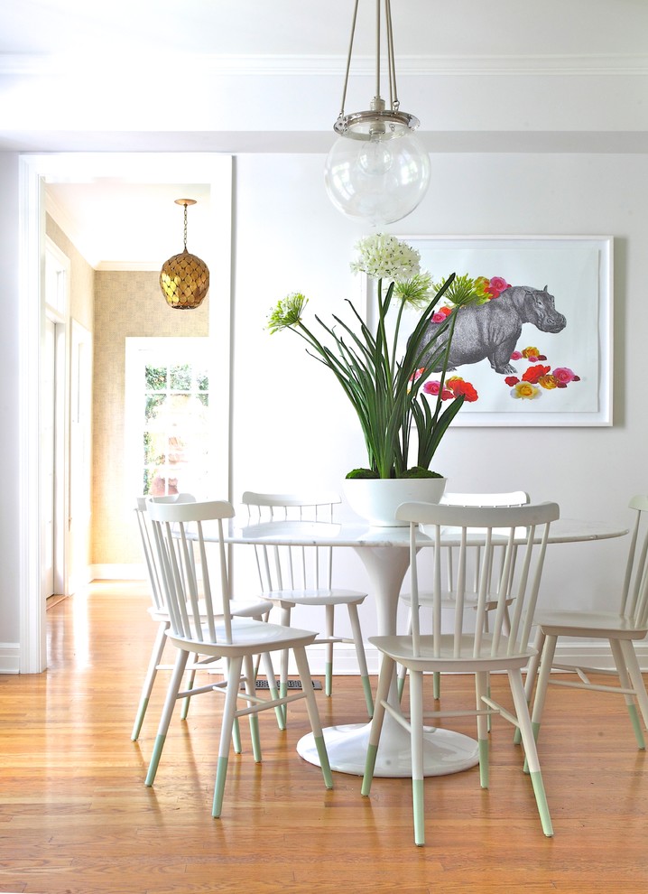 Transitional medium tone wood floor dining room photo in Los Angeles with white walls