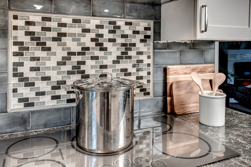 Mid-sized transitional l-shaped medium tone wood floor and brown floor eat-in kitchen photo in Seattle with a double-bowl sink, shaker cabinets, white cabinets, quartz countertops, gray backsplash, ceramic backsplash, stainless steel appliances, two islands and gray countertops