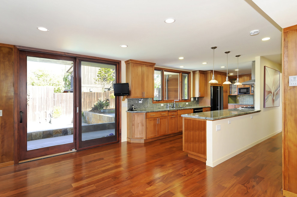 Design ideas for a traditional u-shaped kitchen in San Francisco with medium wood cabinets and black appliances.