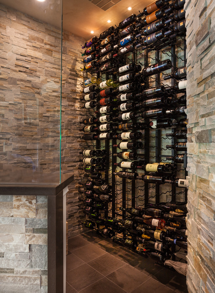 This is an example of a small transitional wine cellar in Dallas with porcelain floors and storage racks.