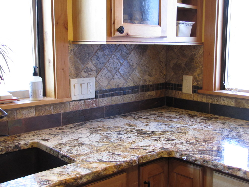 Eat-in kitchen - small rustic u-shaped ceramic tile eat-in kitchen idea in Seattle with a double-bowl sink, light wood cabinets, granite countertops, multicolored backsplash, stone tile backsplash, stainless steel appliances and no island