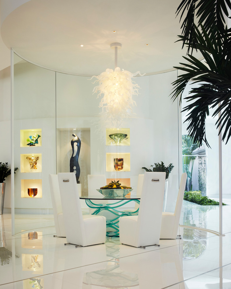 This is an example of a contemporary dining room in Miami with white walls and white floor.