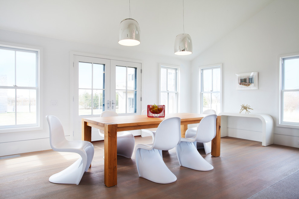 Design ideas for a large beach style dining room in Boston with white walls and medium hardwood floors.