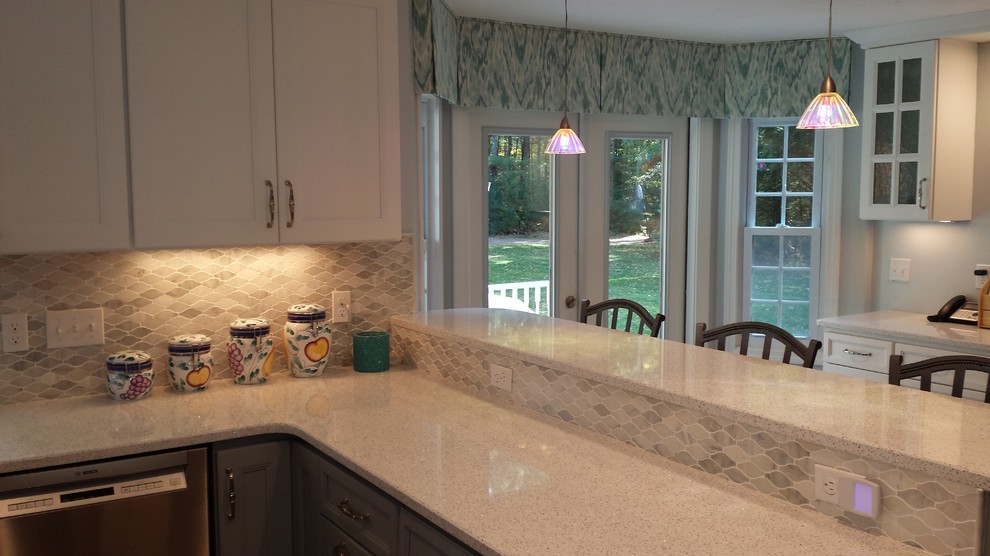 Mid-sized transitional u-shaped light wood floor kitchen photo in Boston with an undermount sink, quartz countertops, stainless steel appliances and a peninsula