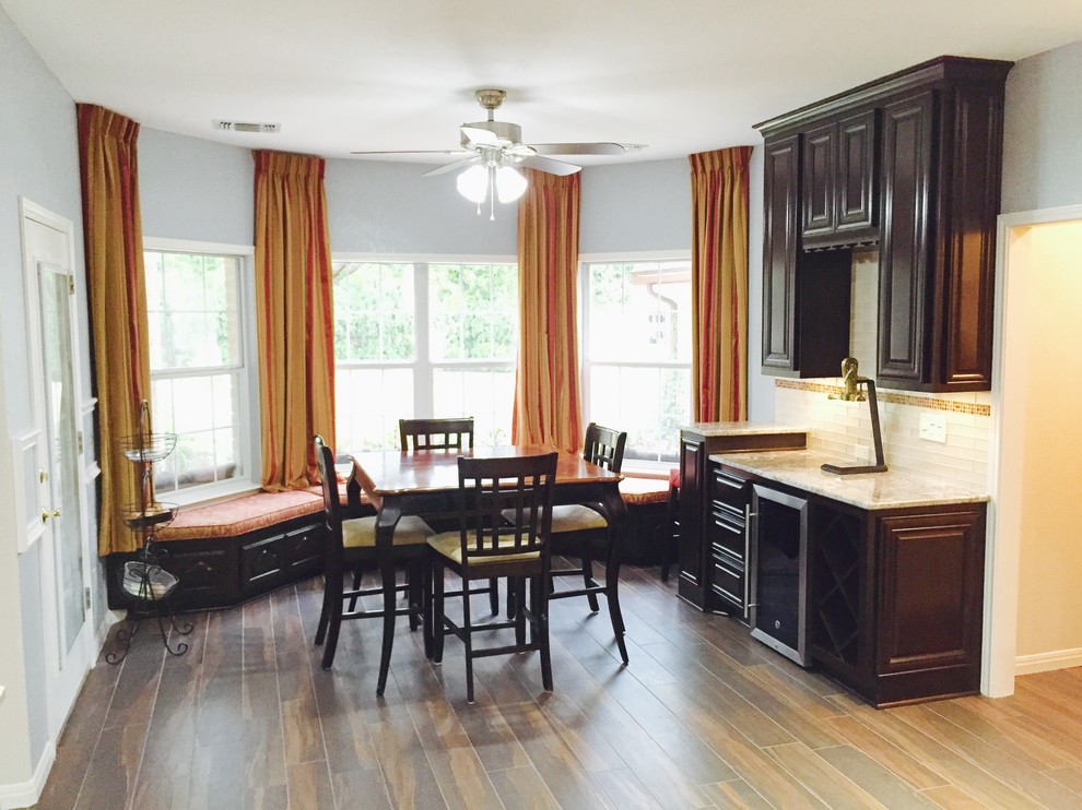 Kitchen/dining room combo - mid-sized transitional medium tone wood floor and brown floor kitchen/dining room combo idea in Austin with gray walls and no fireplace