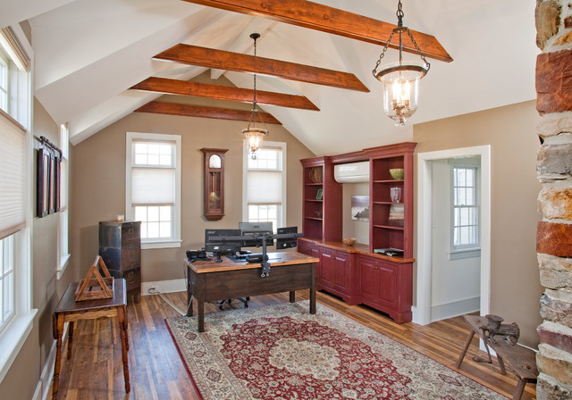 Mid-sized country home office in Philadelphia with beige walls, medium hardwood floors and a built-in desk.
