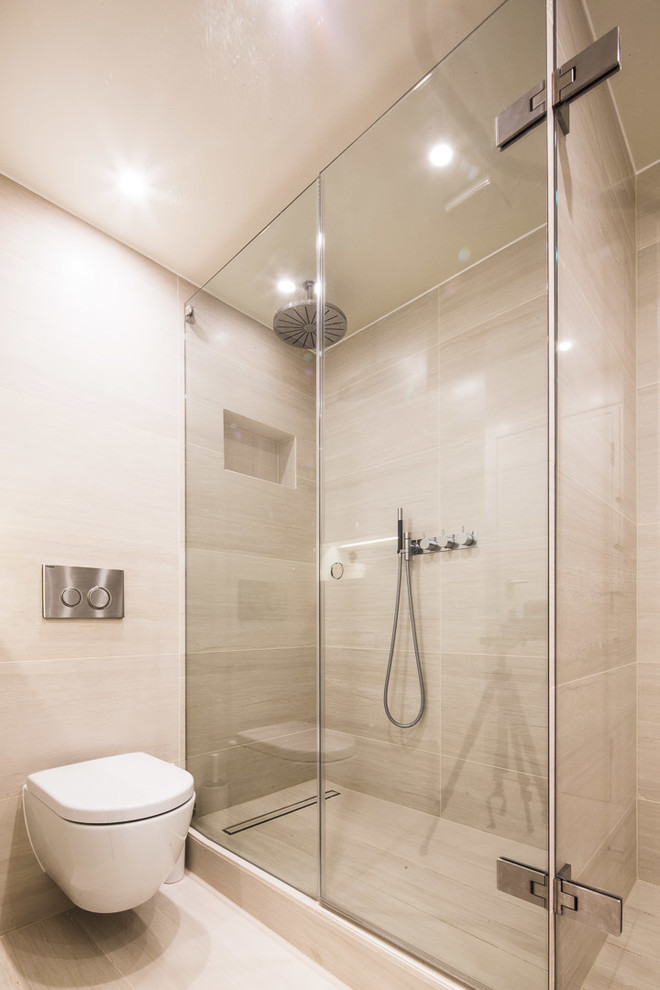 Inspiration for a small contemporary 3/4 bathroom in London with a curbless shower, a wall-mount toilet, beige tile, ceramic tile, beige walls, ceramic floors, a vessel sink, beige floor and a hinged shower door.