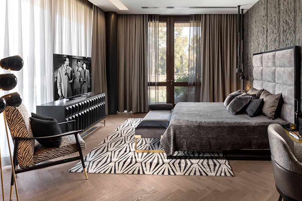 Photo of a world-inspired bedroom in Moscow with dark hardwood flooring.