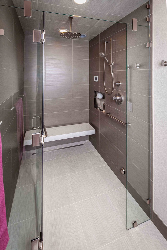 This is an example of a large contemporary master bathroom in Seattle with a freestanding tub, a corner shower, white tile, ceramic tile, beige walls, ceramic floors and a shower seat.