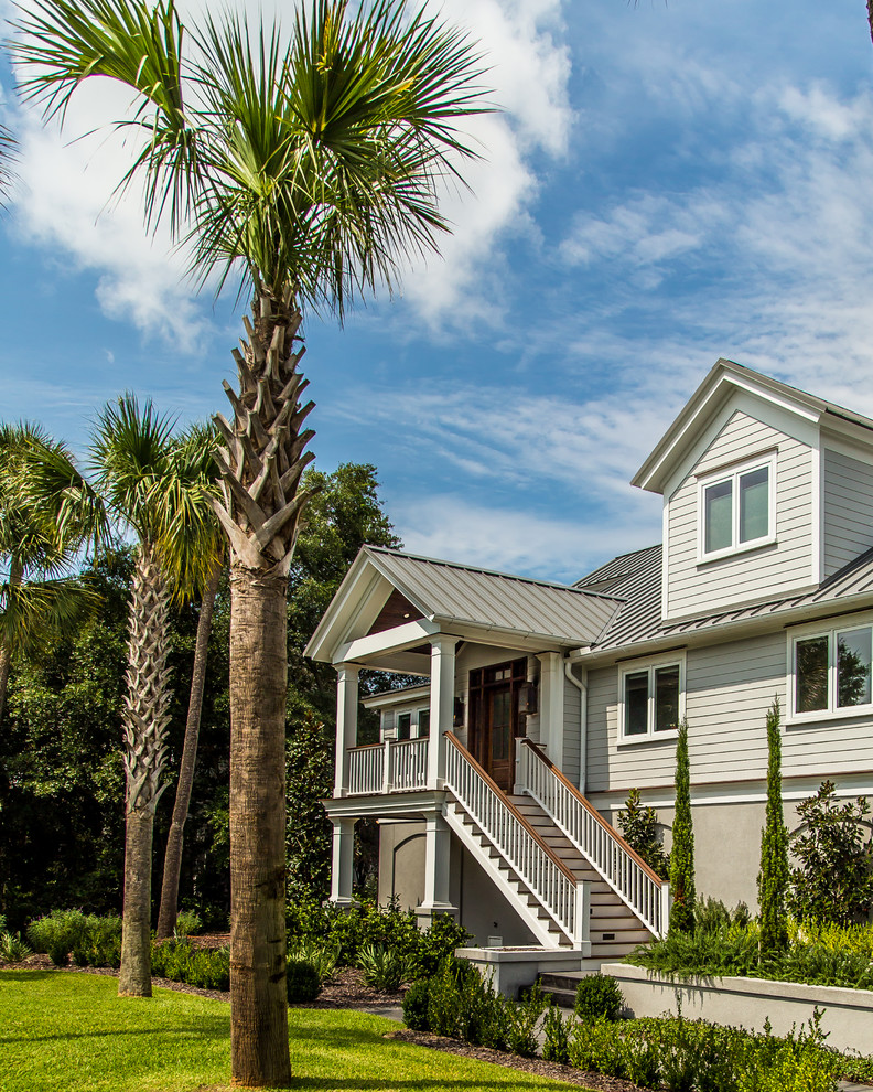 This is an example of a large beach style three-storey grey exterior in Charleston with mixed siding and a gable roof.