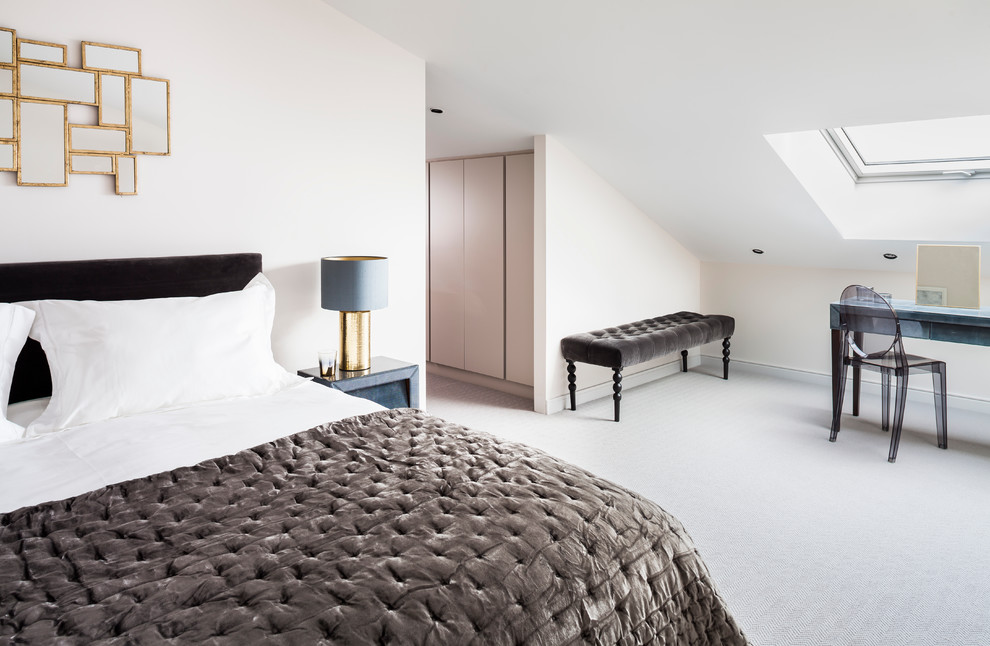Inspiration for a mid-sized contemporary master bedroom in London with white walls and carpet.