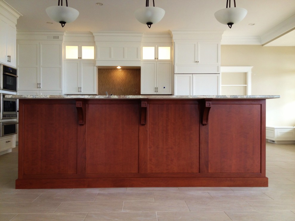 Inspiration for a transitional ceramic tile eat-in kitchen remodel in Boston with a double-bowl sink, recessed-panel cabinets, white cabinets, quartz countertops, brown backsplash, glass tile backsplash, stainless steel appliances and an island