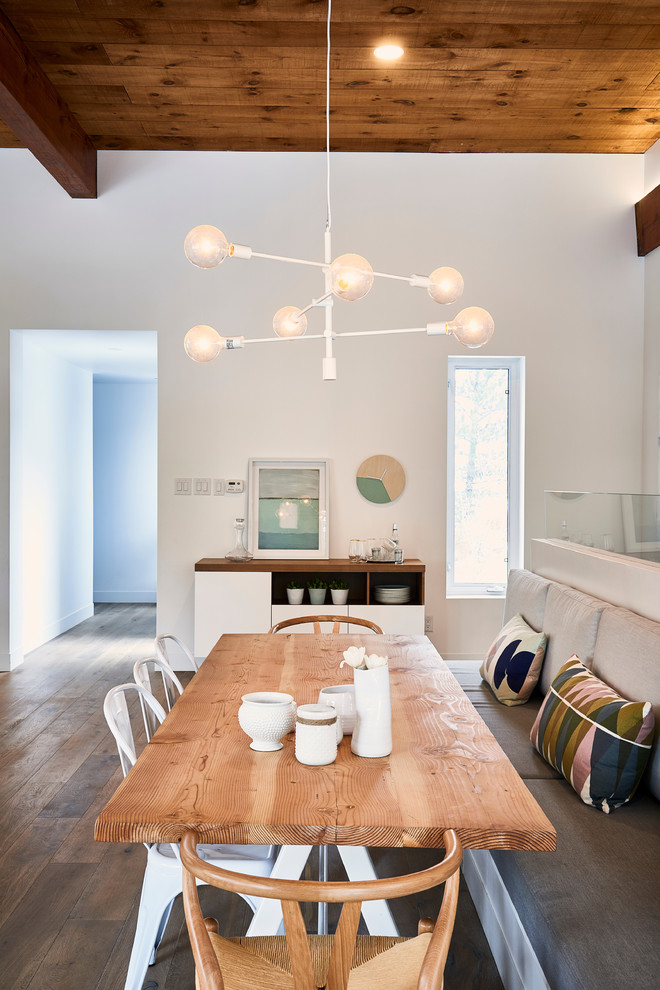 This is an example of a scandinavian open plan dining in Toronto with white walls and light hardwood floors.