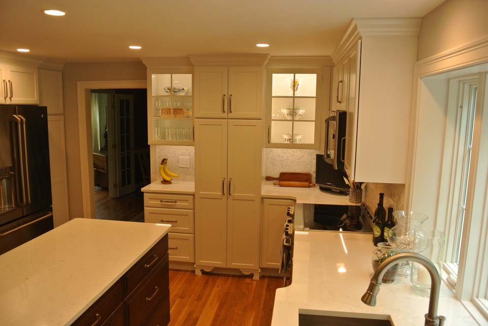 Inspiration for a transitional medium tone wood floor eat-in kitchen remodel in Boston with an undermount sink, shaker cabinets, quartz countertops, beige backsplash, mosaic tile backsplash, stainless steel appliances, an island and white countertops