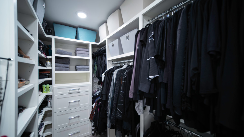 Photo of a small modern gender-neutral walk-in wardrobe in Other with recessed-panel cabinets and white cabinets.