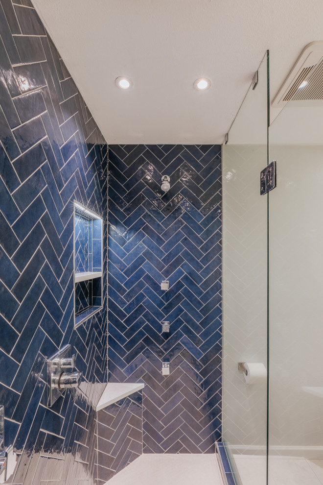 This is an example of a small modern ensuite bathroom in Portland with grey cabinets, an alcove shower, blue tiles, ceramic tiles, white walls, engineered stone worktops, a hinged door, white worktops, a wall niche, double sinks and a built in vanity unit.