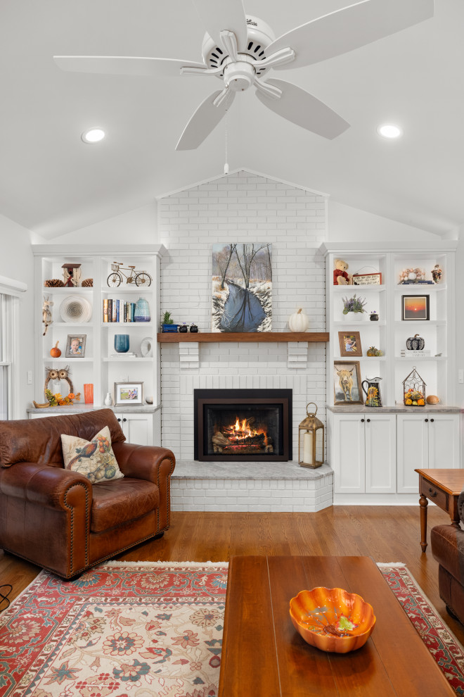Example of a mid-sized transitional kitchen design in DC Metro with shaker cabinets, white cabinets, quartz countertops, porcelain backsplash, stainless steel appliances and an island