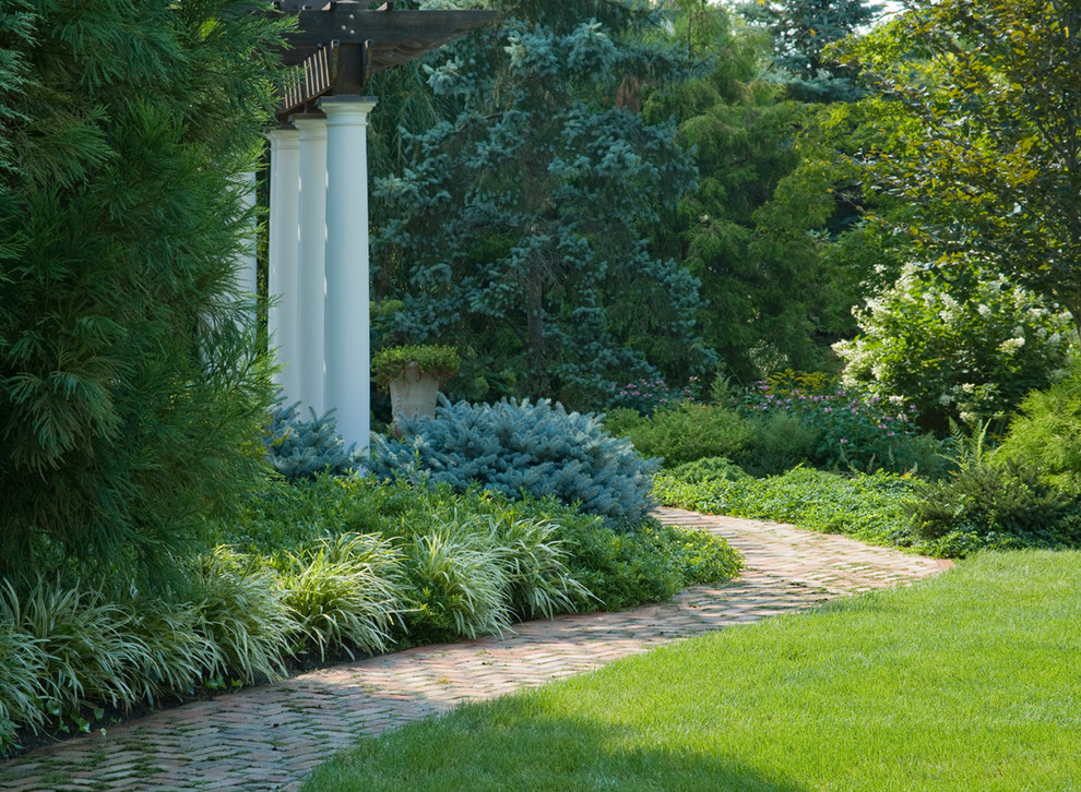 Large traditional side yard partial sun formal garden in New York with brick pavers for summer.