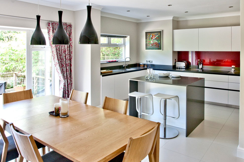 This is an example of a mid-sized contemporary kitchen/dining combo in Surrey with grey walls.