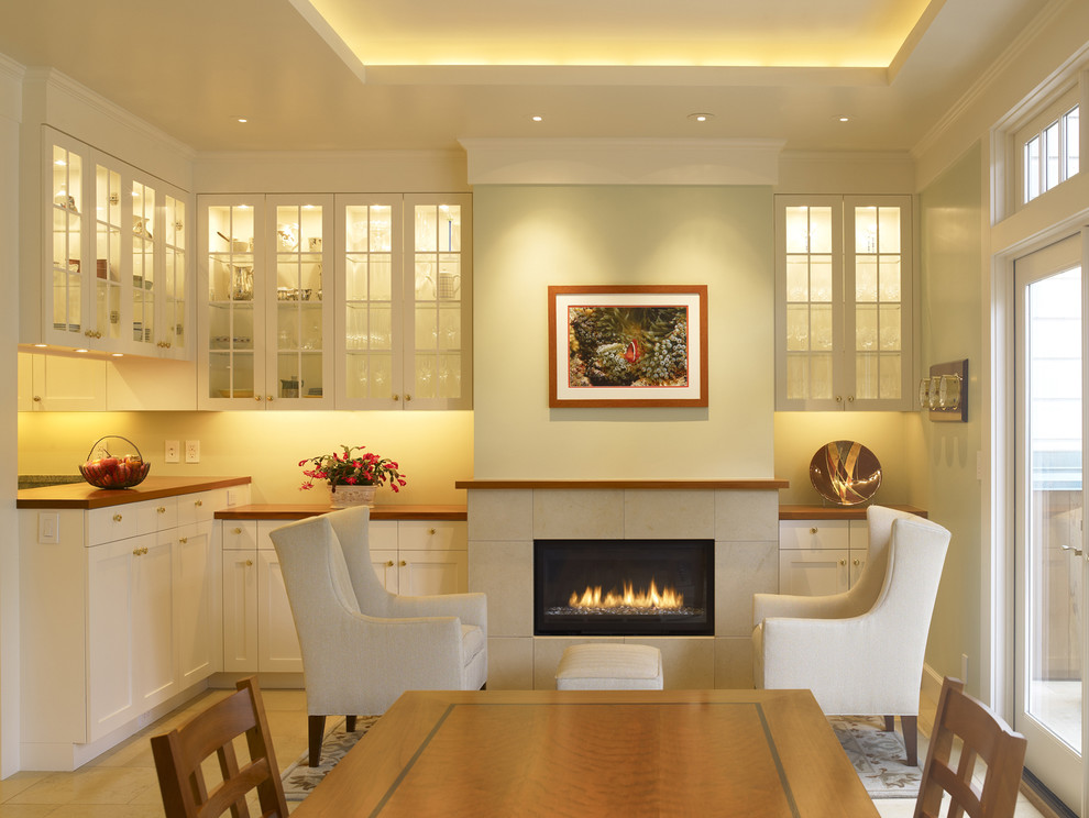Photo of a traditional dining room in San Francisco with beige walls and a ribbon fireplace.
