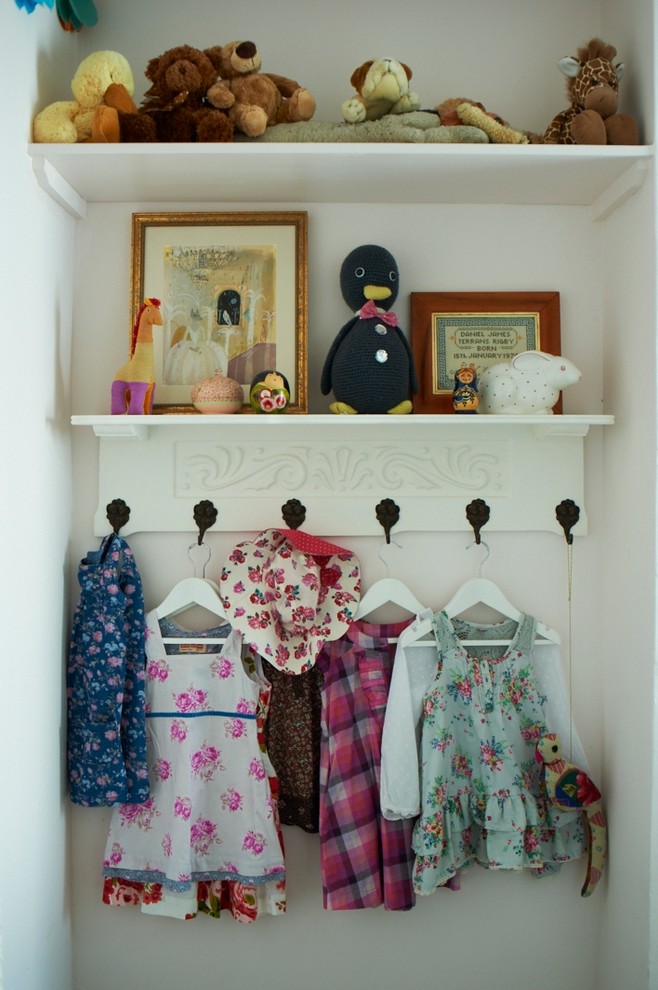 Eclectic storage and wardrobe in London with light hardwood floors.