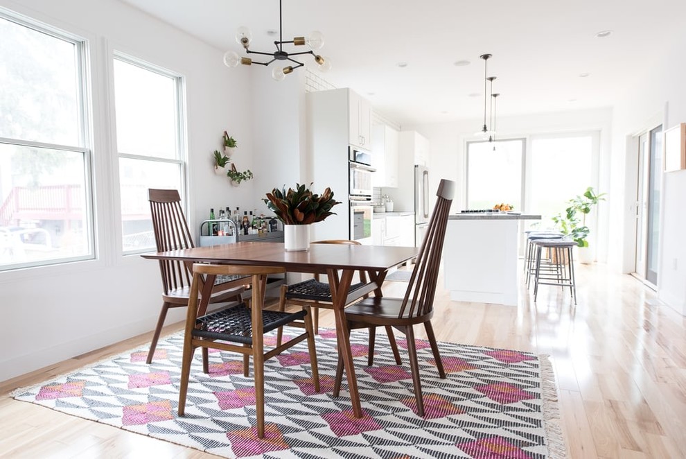 Design ideas for a transitional kitchen/dining combo in DC Metro with light hardwood floors, white walls, no fireplace and pink floor.