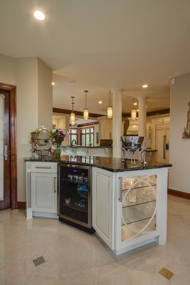 Inspiration for an expansive mediterranean u-shaped home bar in Milwaukee with raised-panel cabinets, white cabinets, granite benchtops, marble floors and white floor.
