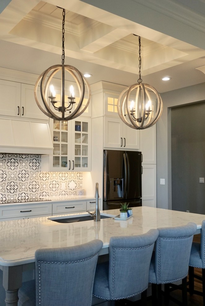 Inspiration for a large transitional l-shaped medium tone wood floor kitchen pantry remodel in Cedar Rapids with an undermount sink, shaker cabinets, white cabinets, quartz countertops, multicolored backsplash, cement tile backsplash, stainless steel appliances and an island