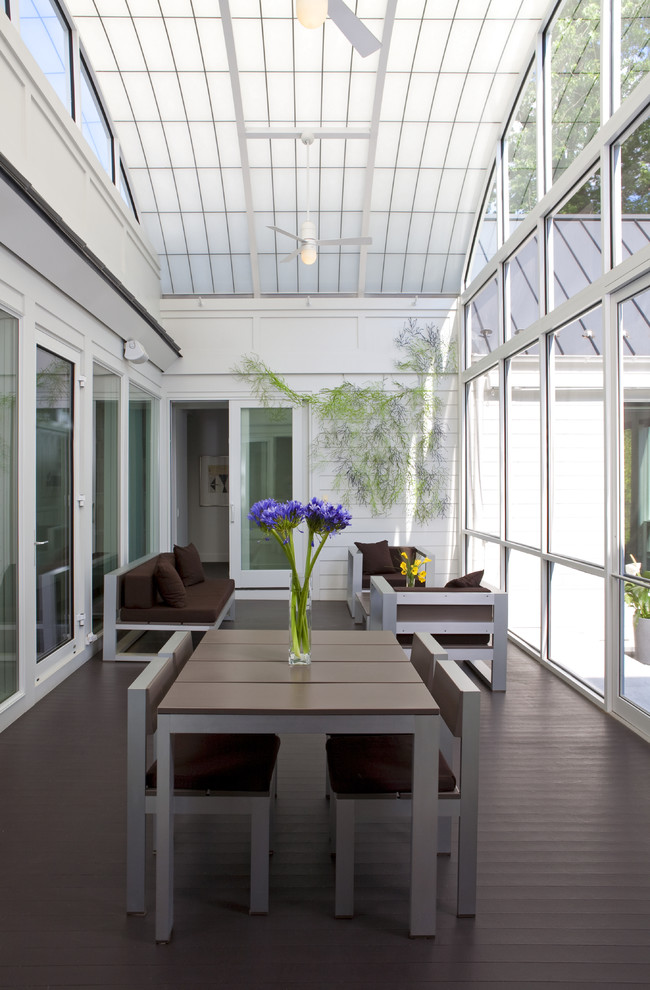 Design ideas for a transitional sunroom in DC Metro with dark hardwood floors, a glass ceiling and brown floor.