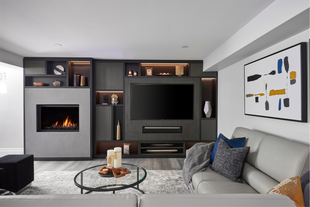 Contemporary family room in Toronto with white walls, a wall-mounted tv and grey floor.