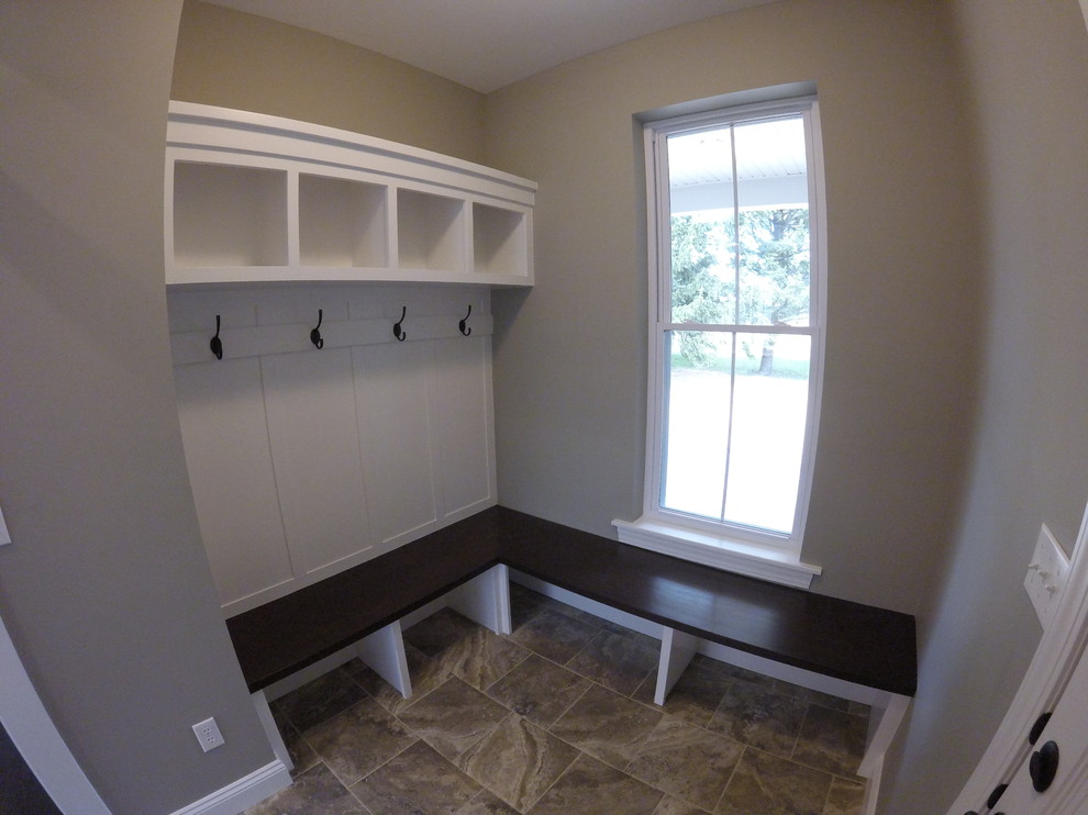 Mid-sized arts and crafts gender-neutral walk-in wardrobe in St Louis with open cabinets and white cabinets.