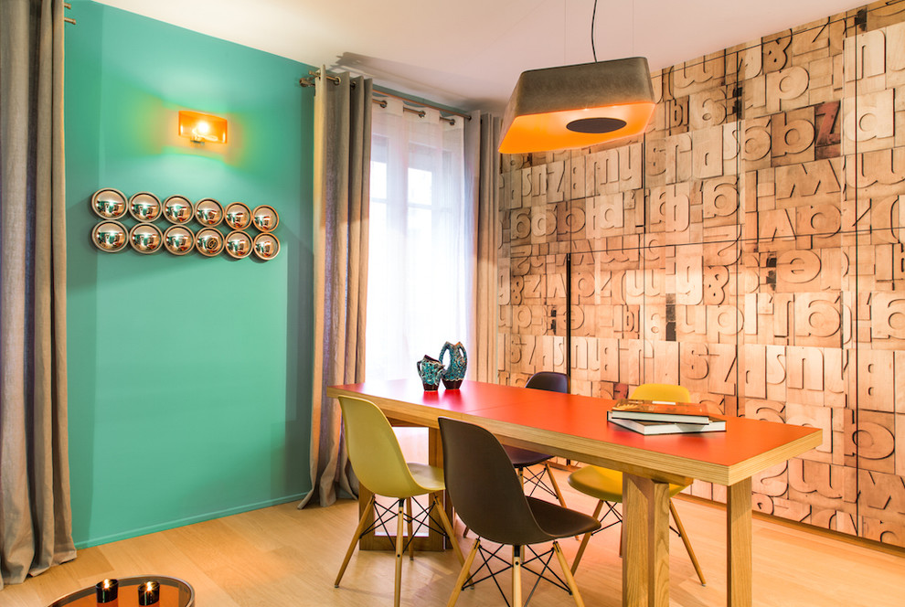 Photo of a large contemporary separate dining room in Paris with light hardwood floors, green walls and no fireplace.