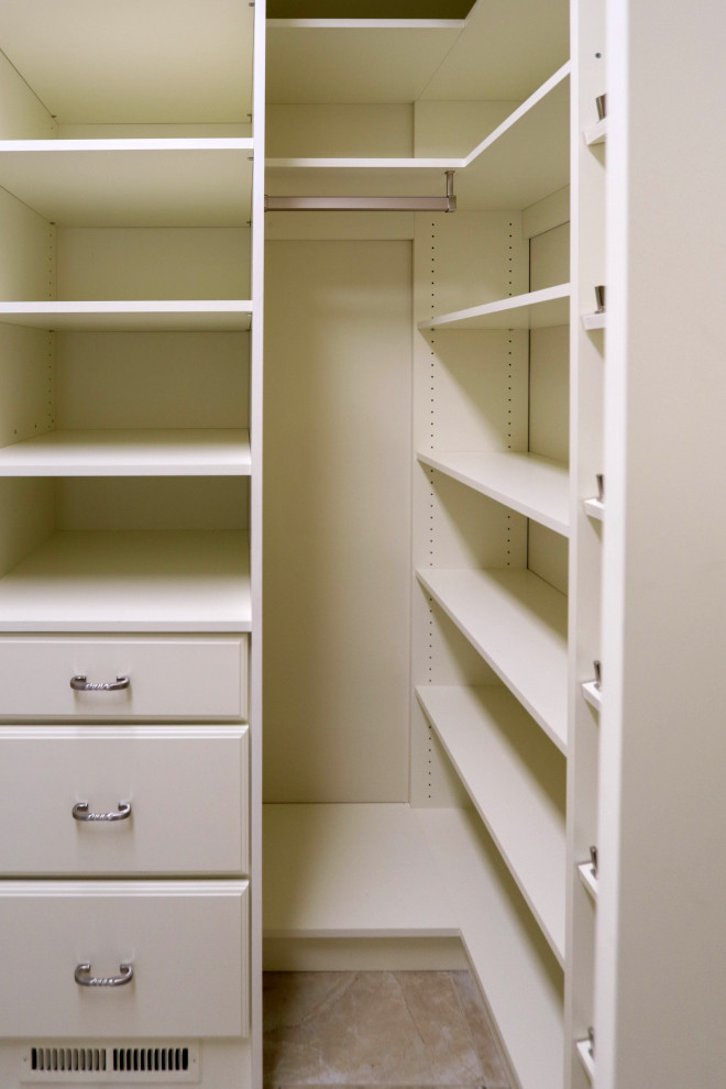 Inspiration for a mid-sized transitional walk-in wardrobe in Cleveland with beige cabinets, ceramic floors and beige floor.
