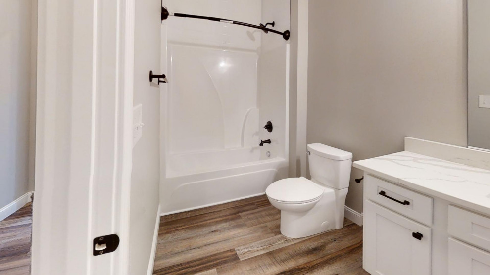 This is an example of a classic bathroom in Louisville with shaker cabinets, white cabinets, white tiles, metro tiles, engineered stone worktops, brown floors, a shower curtain, white worktops, a single sink and a built in vanity unit.