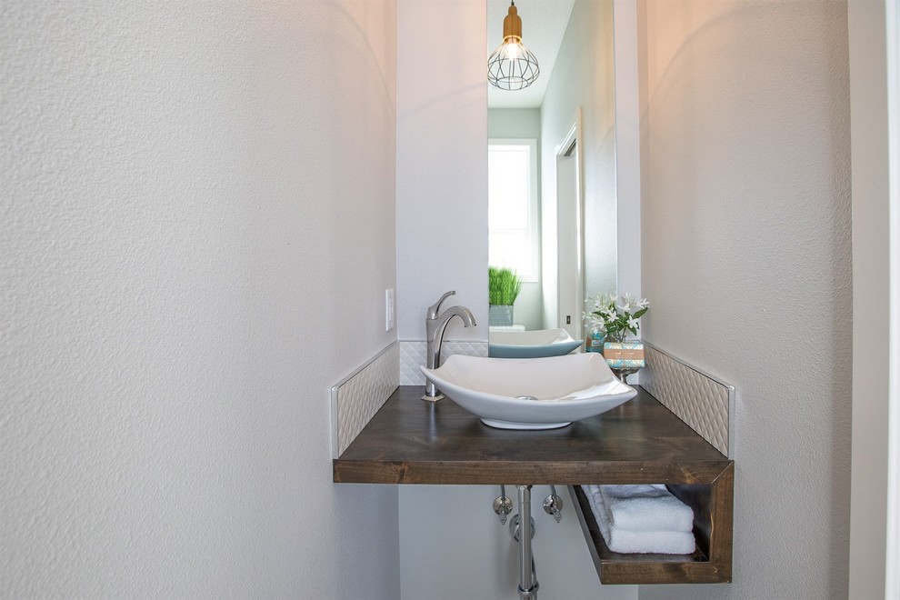 This is an example of a transitional powder room in Seattle.