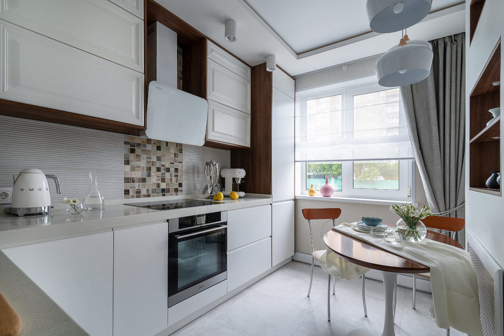 Photo of a contemporary l-shaped separate kitchen in Moscow with flat-panel cabinets, white cabinets, beige splashback, stainless steel appliances, white floor and white benchtop.