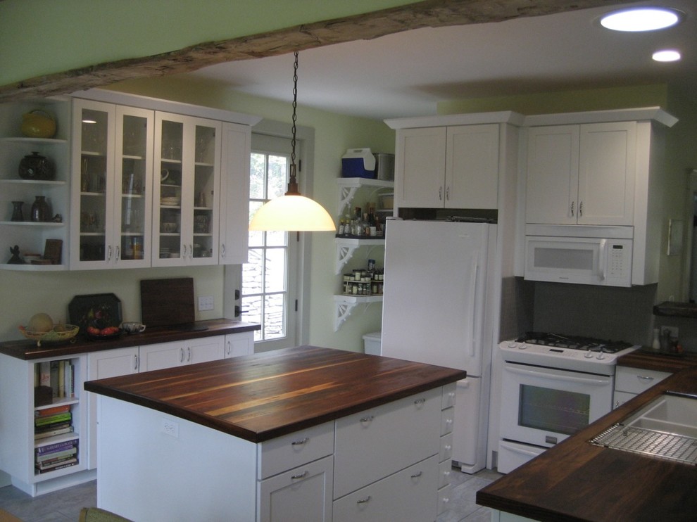 Inspiration for a mid-sized transitional l-shaped kitchen in Cincinnati with with island, shaker cabinets, white cabinets, wood benchtops, white appliances and an undermount sink.
