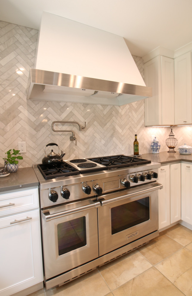 Inspiration for a mid-sized u-shaped ceramic tile, beige floor and exposed beam eat-in kitchen remodel in Denver with a single-bowl sink, flat-panel cabinets, white cabinets, quartz countertops, gray backsplash, marble backsplash, stainless steel appliances, an island and gray countertops