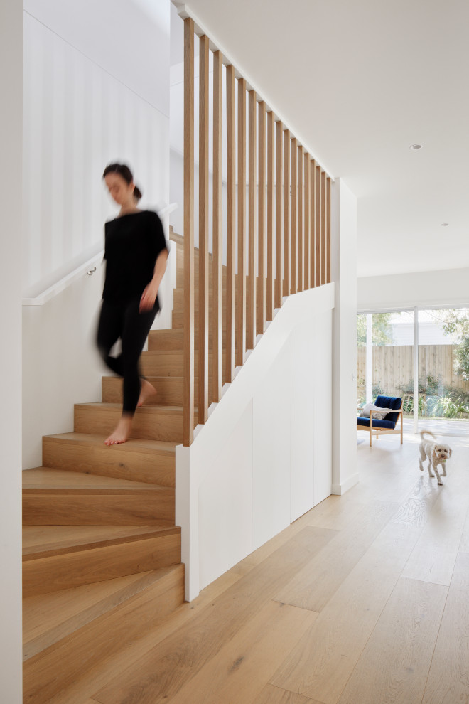 Staircase - scandinavian wooden spiral wood railing staircase idea in Melbourne with wooden risers